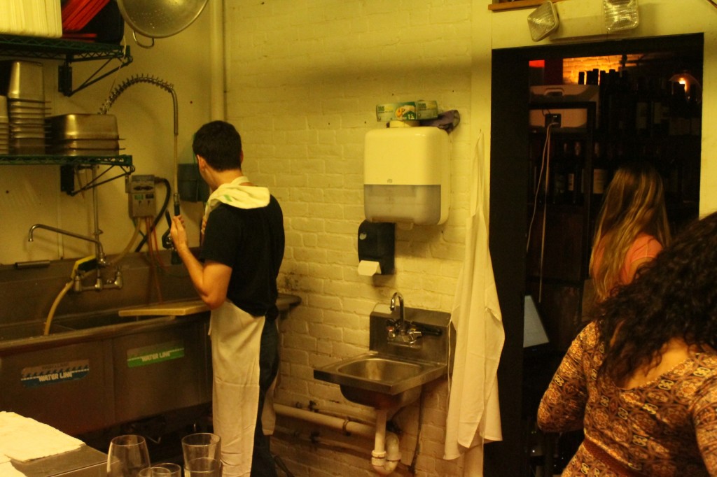 McNamara cleaning pots and pans to run back to the kitchen (Photo: Sam MacKay