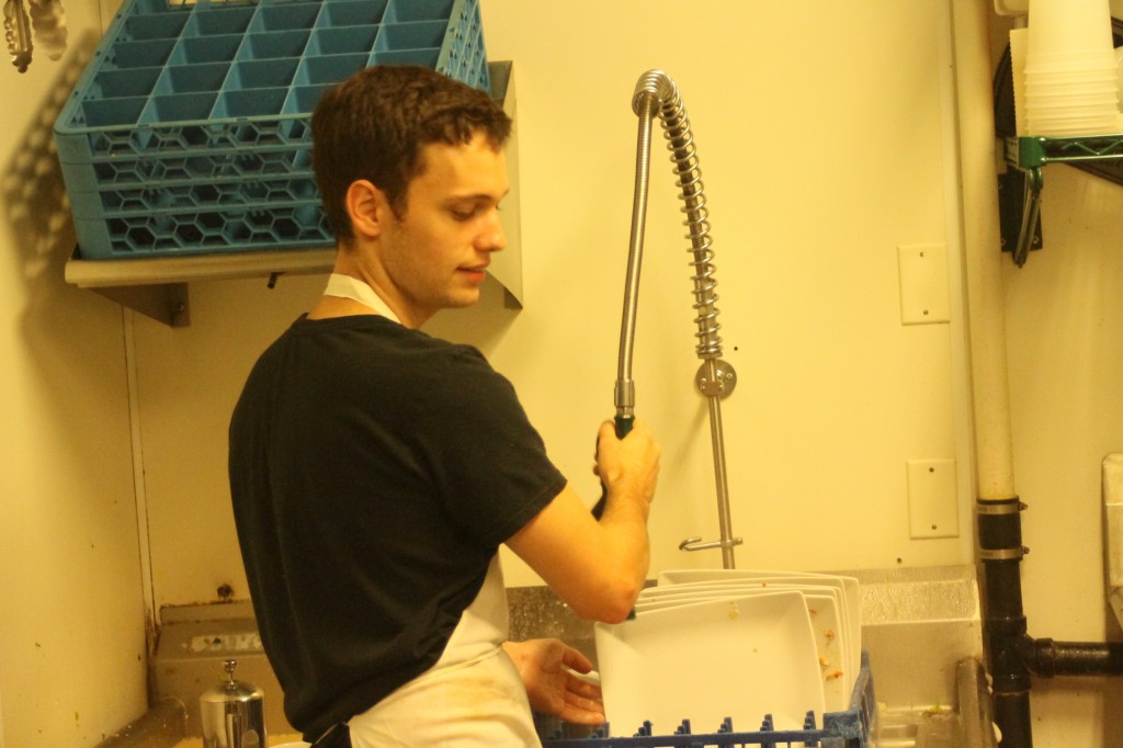 McNamara washes dishes from the dining room (Photo: Sam MacKay)