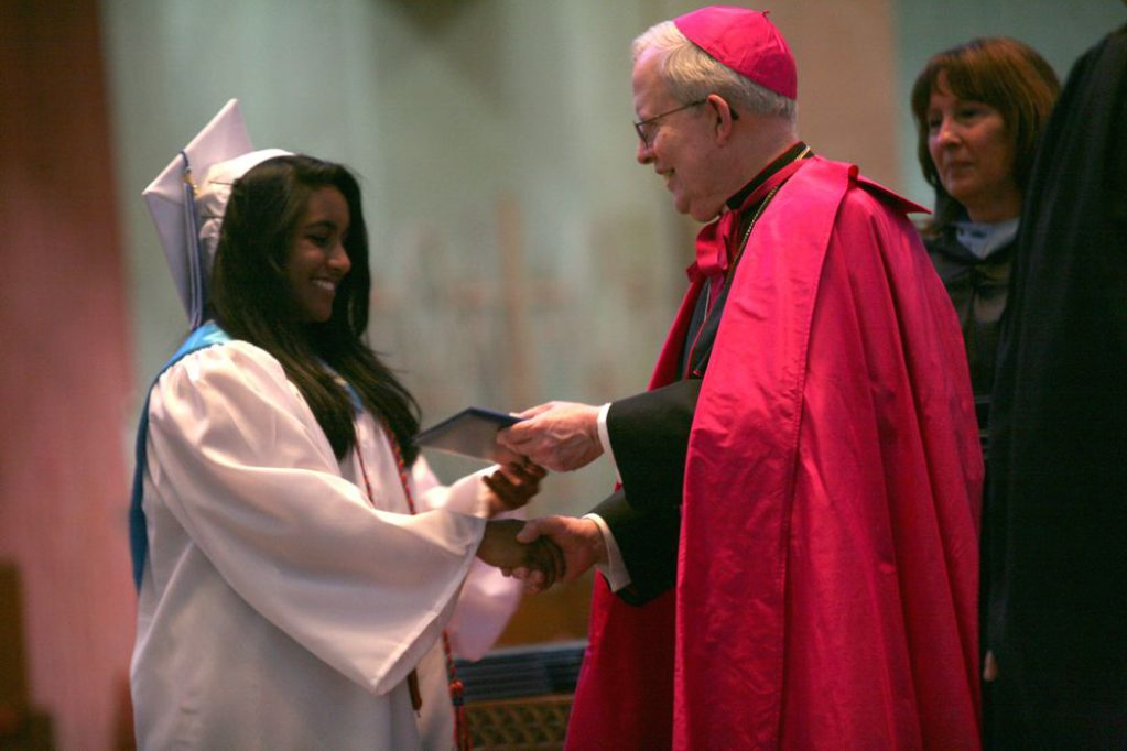 Zarrin Ahmed shakes the hand of the Archbishop of the Diocese of Hartford while receiving her high school diploma, 2011. (David Moran/ Manchester Patch) 