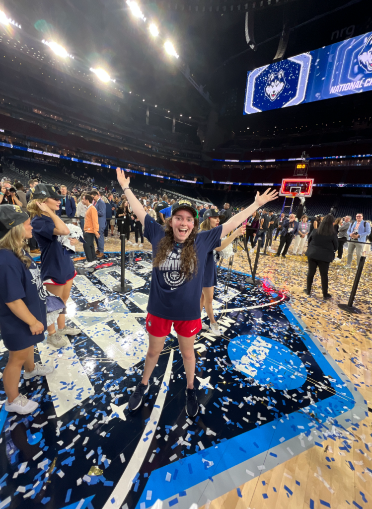 A student celebrates on a basketball court